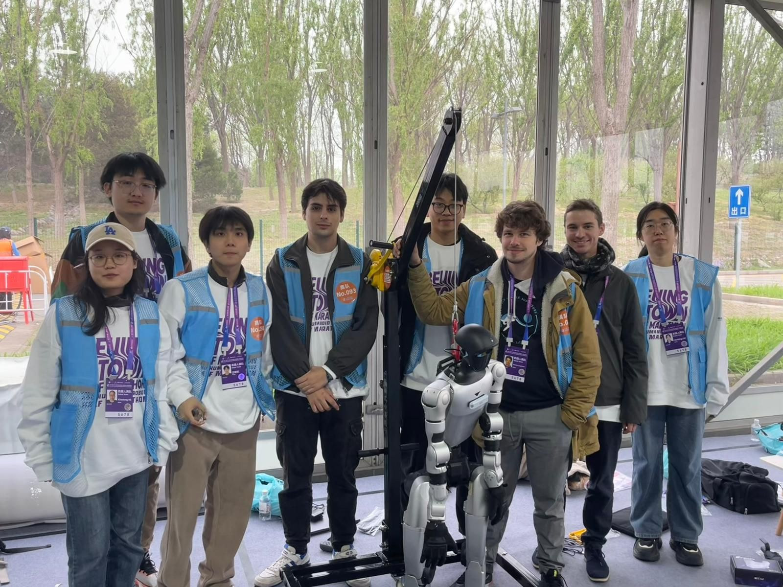 Team members with their humanoid robot at the 2026 Beijing Humanoid Robot Half-Marathon